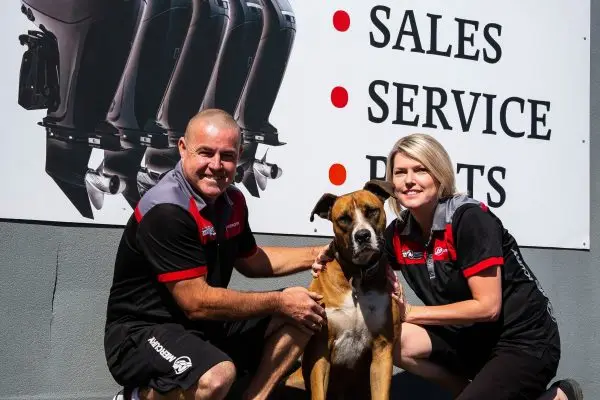 Mike and Shelley with their dog outside Mike’s Marine